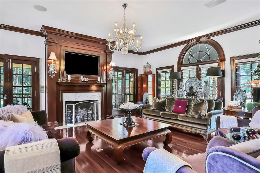 Living room with a fireplace and screened in porch right outside the door.