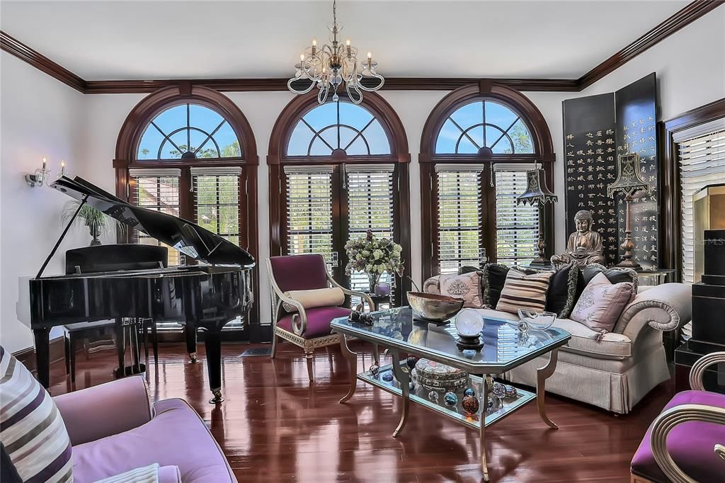 Continuation of the living room overlooking the pool in backyard, all the windows have the original wavy glass.