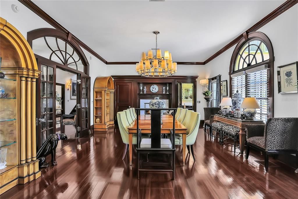 Dining room with fireplace and overlooks the pool and backyard. Connected by a door to the butlers pantry.