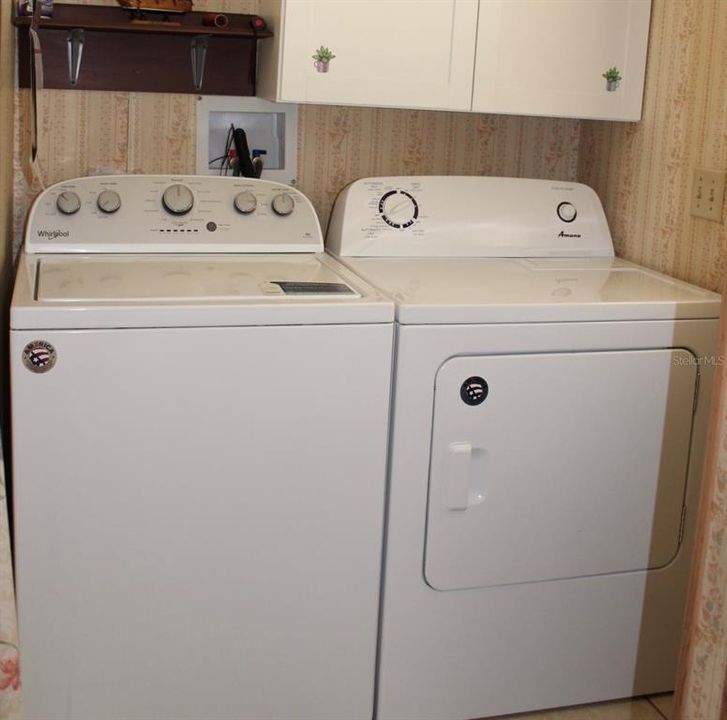 Indoor laundry room with cabinets
