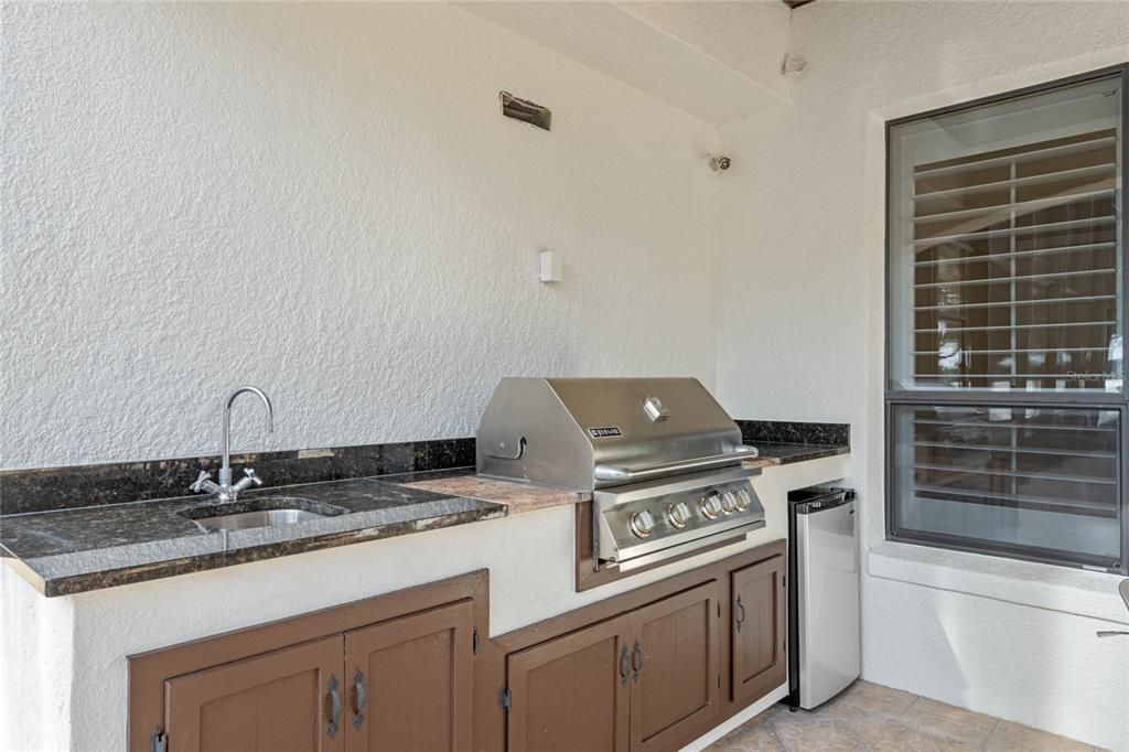 Summer kitchen with grill, refrigerator and sink