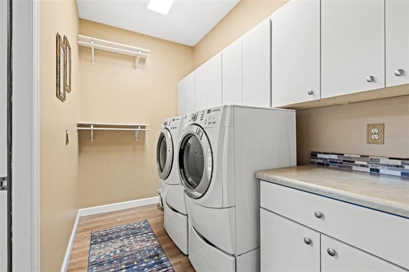 Laundry room with plenty of storage and a utility sink