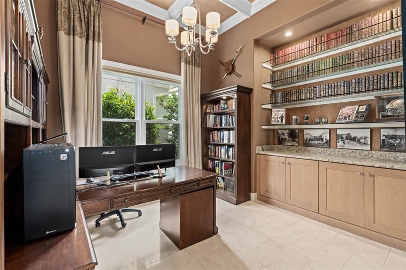 Study/Office has built-in cabinetry and glass bookshelves