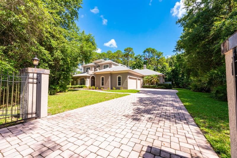 A gated entrance and paver driveway welcome you home!
