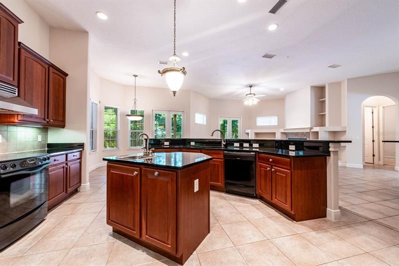 Follow the natural flow into the open kitchen, the family chef will fall in love with the STONE COUNTERS, PREP ISLAND, WALK-IN PANTRY, WALL OVEN and TILED BACKSPLASH!
