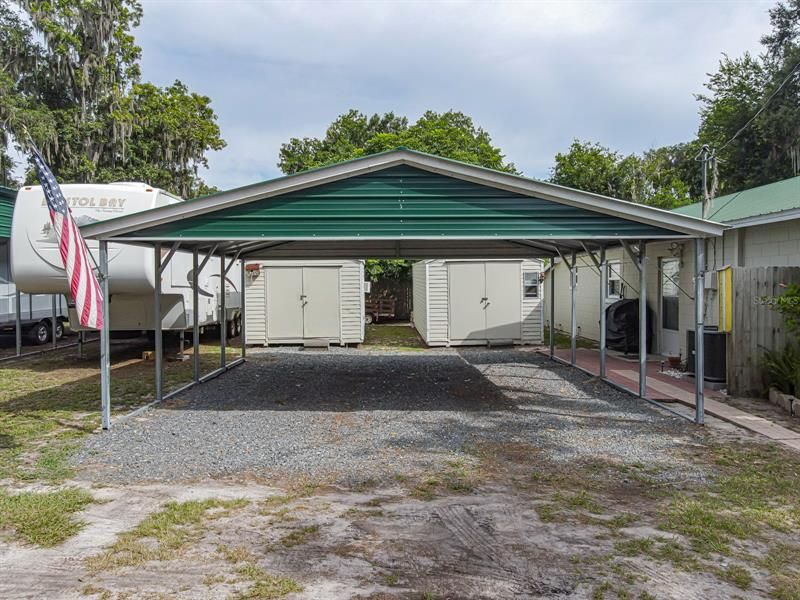 Extra large double carport with shed and workshop to the rear.