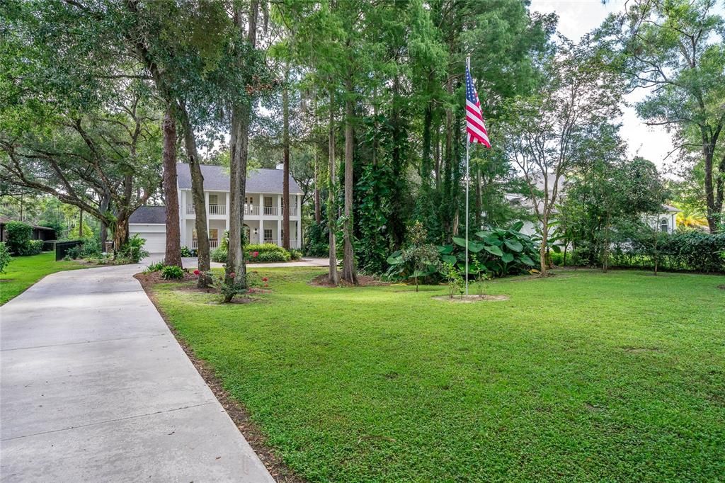 Enter long drive tree lined to beautiful two story home