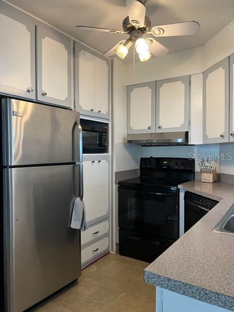 Kitchen with shelf for microwave, pantry to left of refrigerator