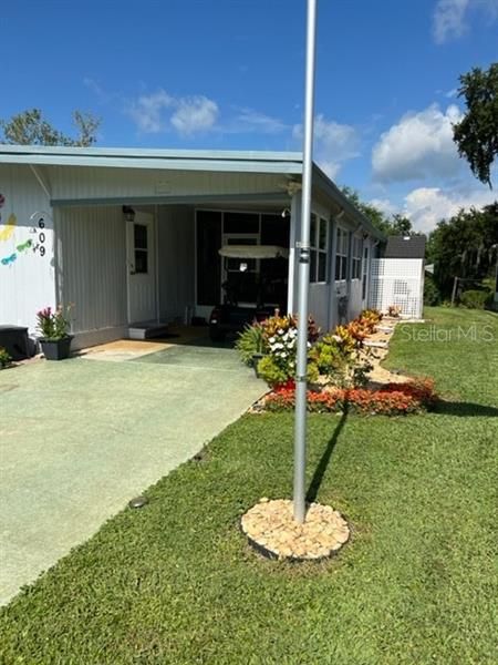 Side view of property, covered carport area