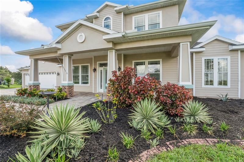 Watch the sunset from this amazing oversized covered front porch