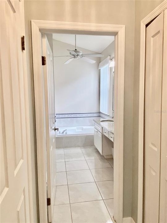 Master bath and his and her closets