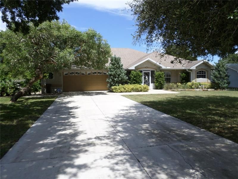 MATURE LANDSCAPING NEW IMPACT WINDOWS AND DOORS