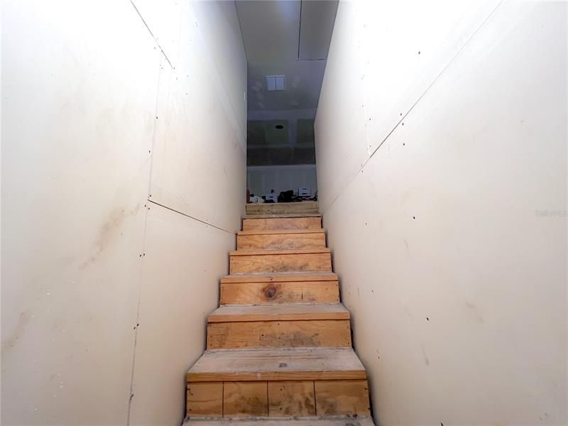 Stairs leading up. to unfinished apartment on 2nd floor