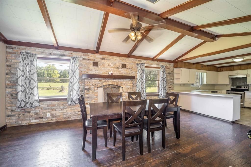 Dining Area with backyard view, high ceilings, and access to spacious kitchen