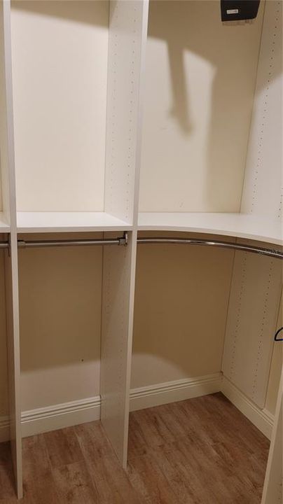 two large walk in closets with organizers