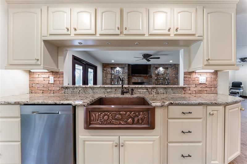 Kitchen cabinets have a warm buttery yellow color.