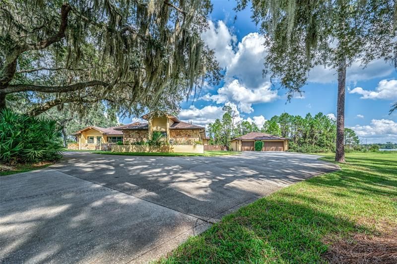 Welcome home!! Custom home on Buck Lake!  This is the right side of the driveway. Detached 3 car garage. Pleny of room for parking.