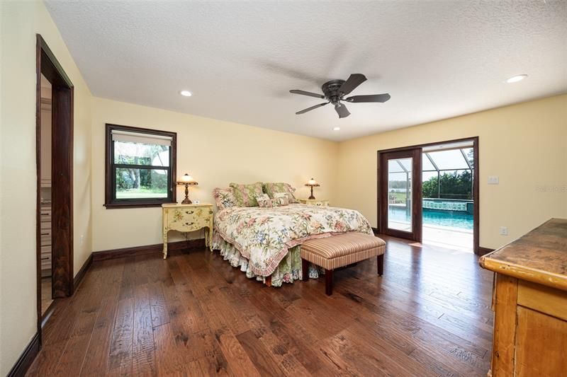 Primary suite with all new flooring, windows, doors and moldings. Step outside to the screened patio & pool.