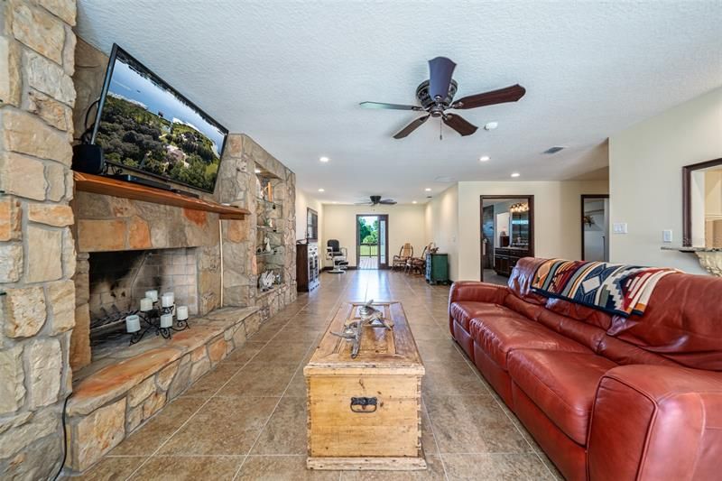 Family room off the kitchen. Owners added custom stone and shelfing surrounding the fire place.