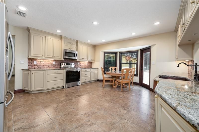 Kitchen has room for dining table as well as a center Island. Center Island was removed to accommodate family needs.