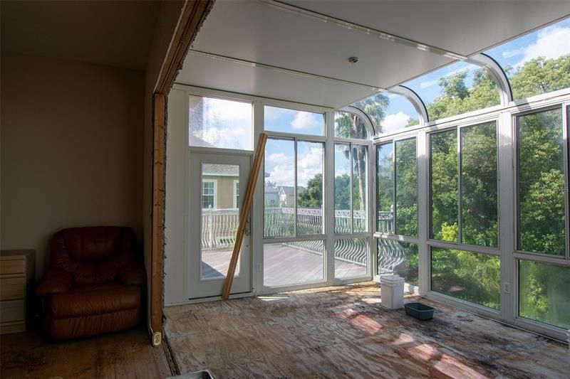 Upstairs sunroom and open balcony with views of the water