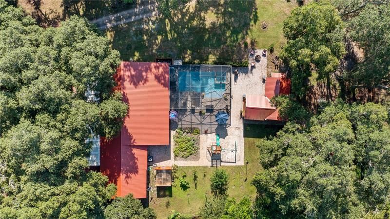 The drone's view of 400 Youth Camp Rd, 4/2 home, pool, garden, playset area, cook shed, pump house...