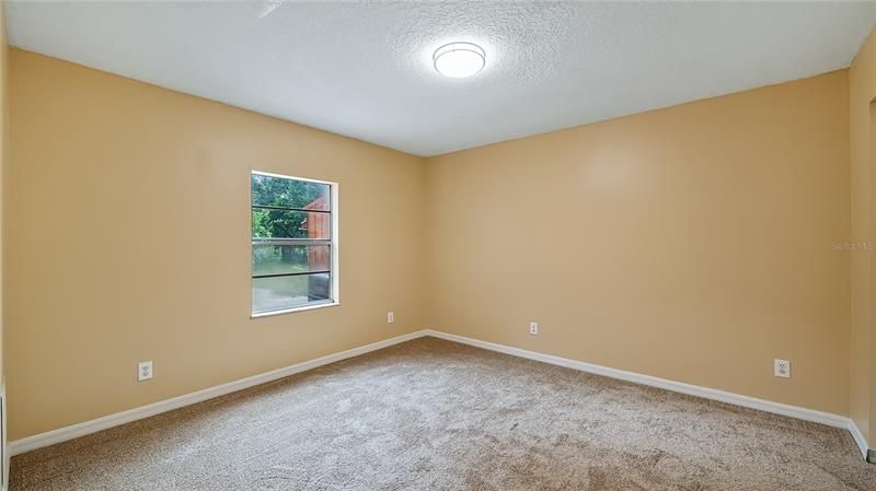 Bedroom #2 with garden & green house view