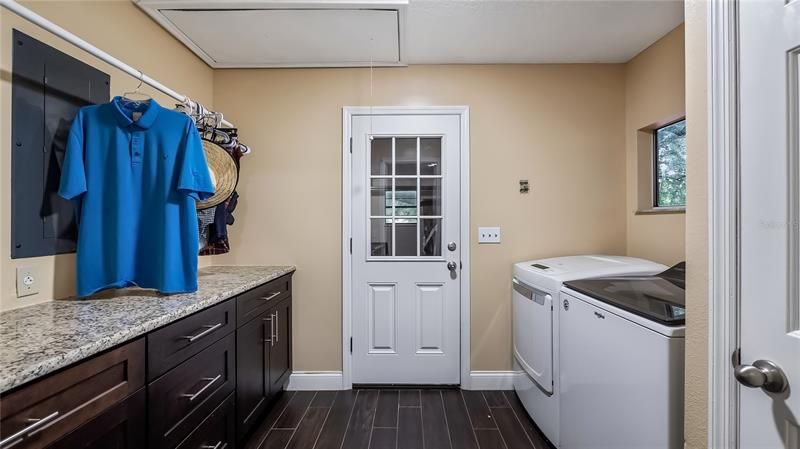 Inside laundry room between garage and kitchen