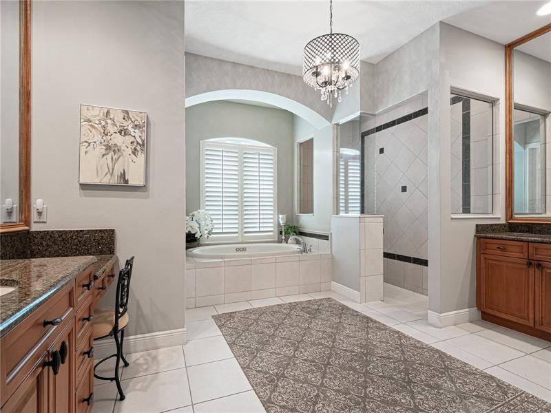 master bathroom with separate vanities and spacious walk-in closet