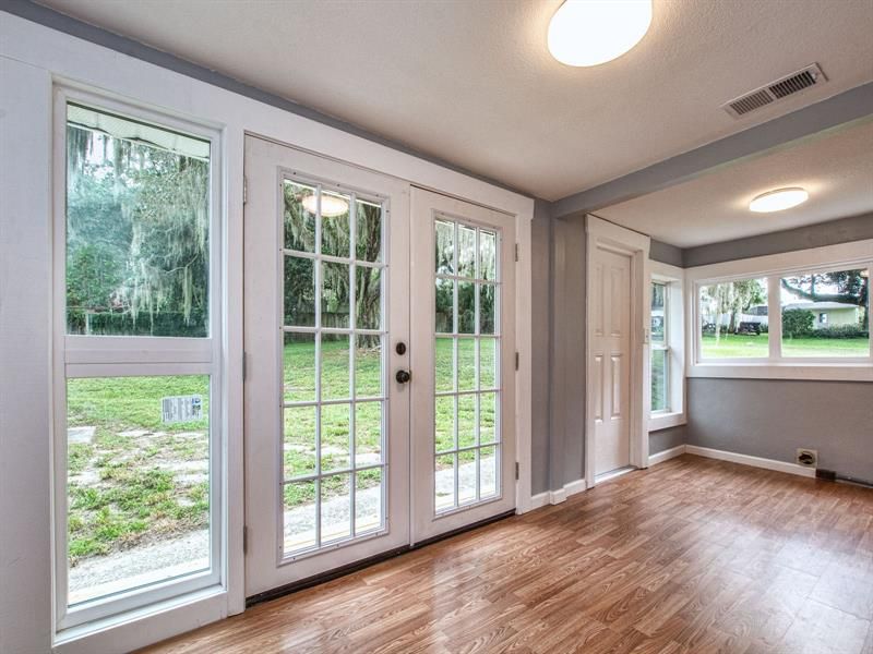 French doors exiting Florida room with small deck outside