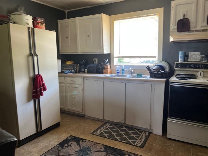 Kitchen with refrigerator and range