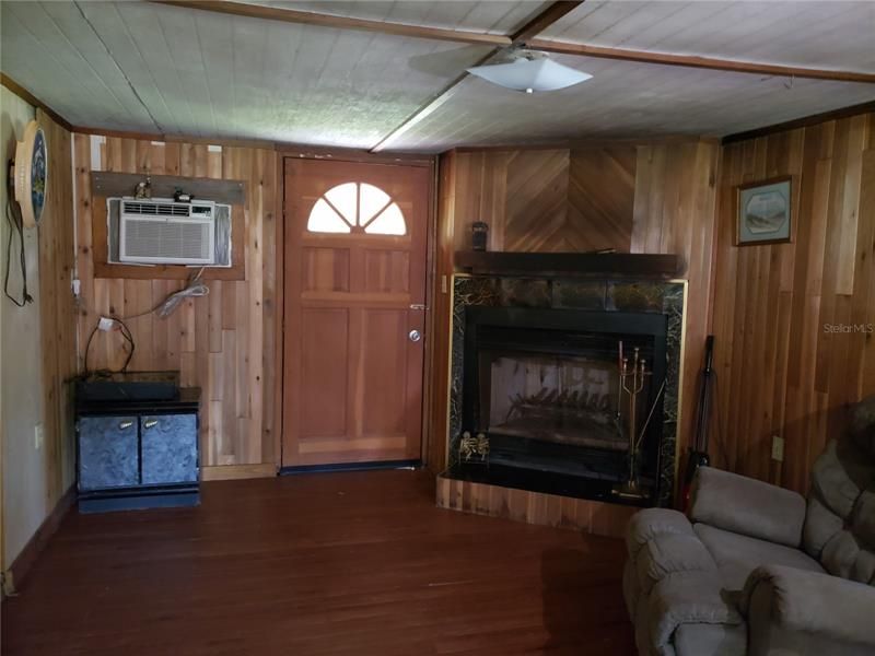 living room w/fireplace. Door to outside backporch area
