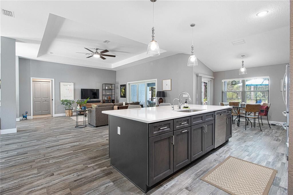 Beautiful kitchen with quartz counter, farm sink and bar area. Also a reverse osmosis system at the sink