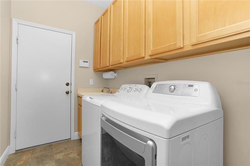 LAUNDRY ROOM WITH UTILITY SINK AND CABINETS