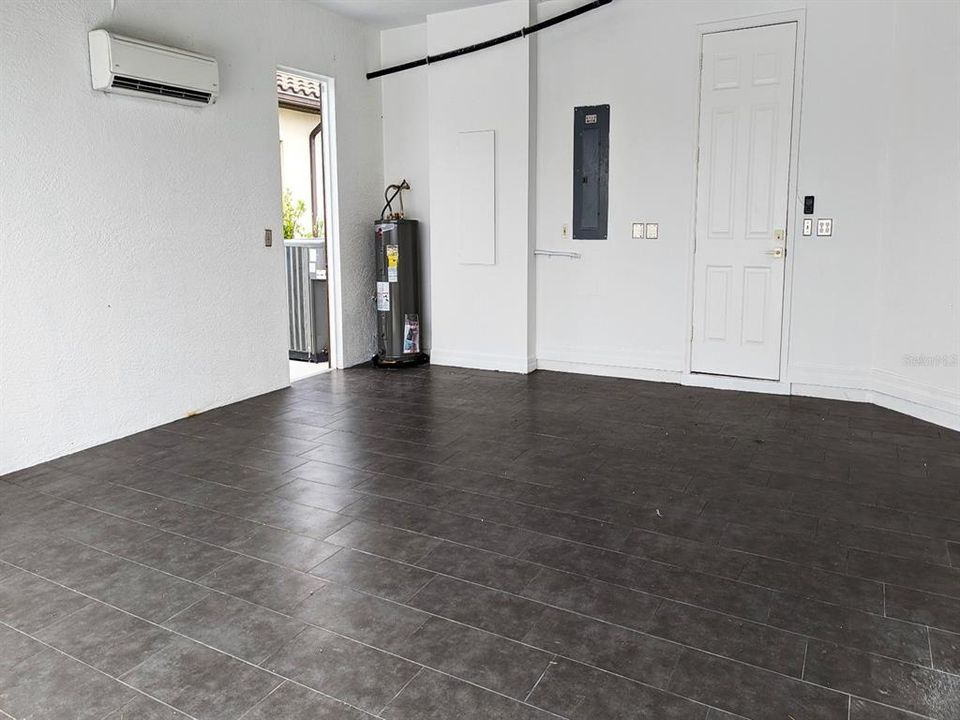 Garage with tile floor and A/C