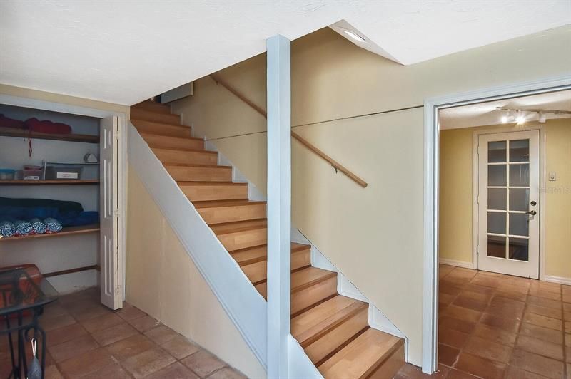Inside stairs with air-conditioned entry, bonus room, and storage