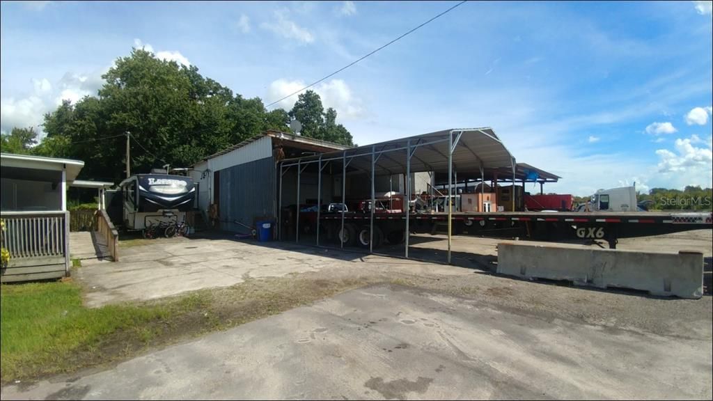 Back enclosed porch on house & first of 8 Truck service bays