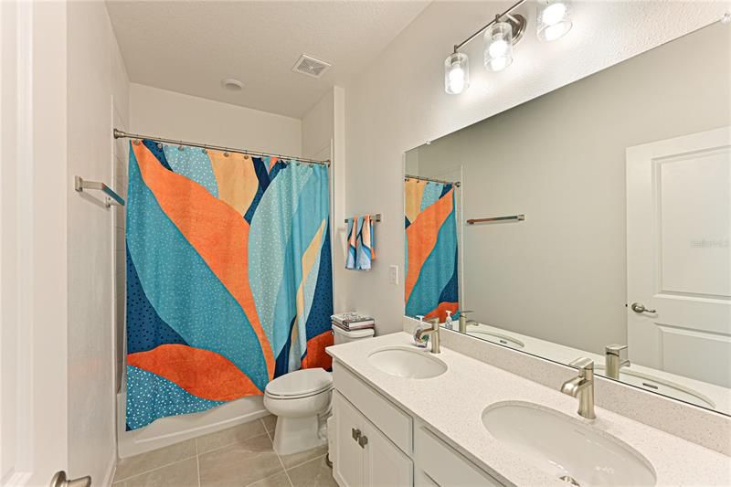 Upstairs Full Guest Bathroom also has dual sinks and upgraded quarz counters with ceramic tile floor