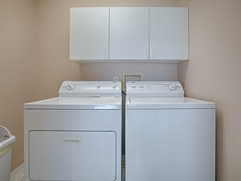INSIDE LAUNDRY ROOM WITH CABINET STORAGE