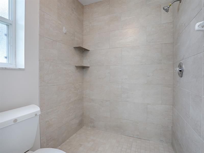 WOW!  LOOK AT THAT SPACIOUS WALK-IN SHOWER AND GORGEOUS TILING!!!