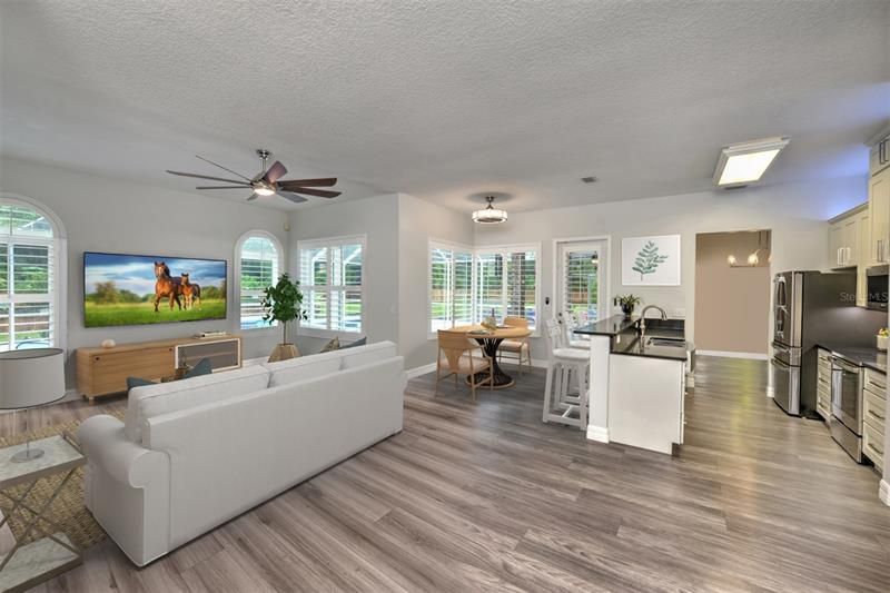 Bright, open floor plan. Family room and open kitchen have a lovely flow for entertaining. Wrap around windows allow you to view the pool at all times.