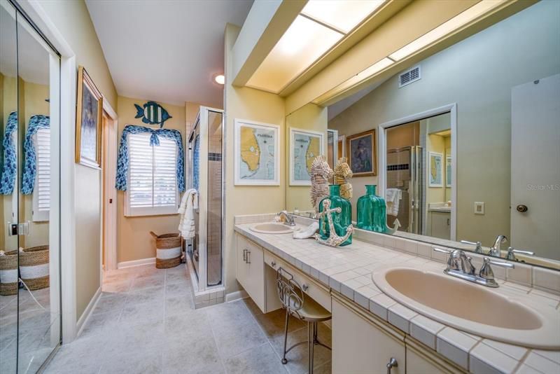 Master bath with dual sinks and a walk in closet.