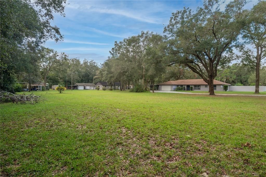 View of property from entrance.  The main home is on right.  Large Barn and garage are in center.  The Mobile home on left