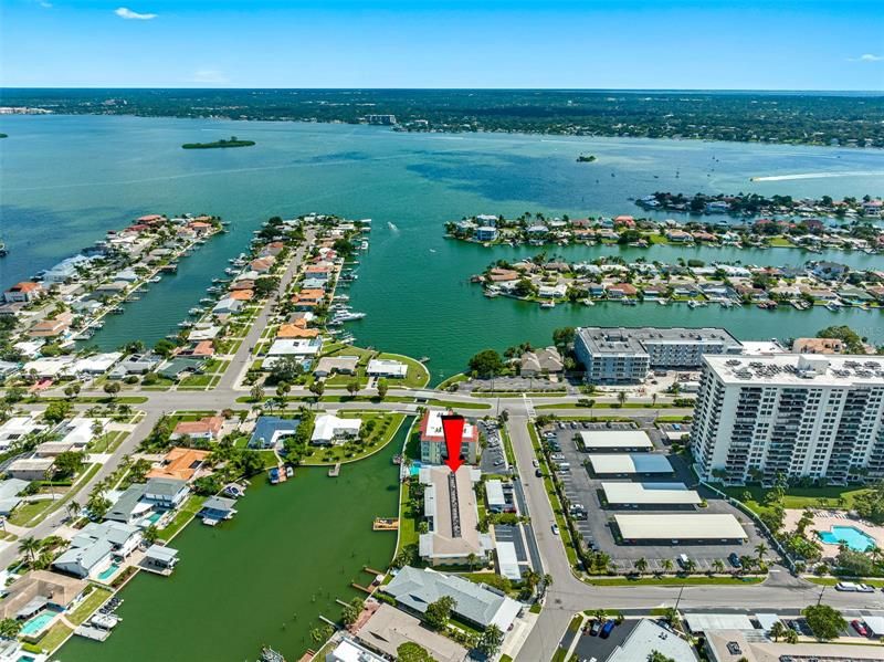 Arial view of red arrow pointing at 270 Skiff Point Building on beautiful, sunny, Island Estates in Clearwater Beach, Florida