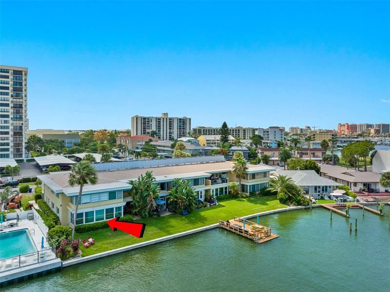 Arial shot of red arrow pointing at the rear view of Unit A-5 at 270 Skiff Point on beautiful, sunny, Island Estates in Clearwater Beach, Florida