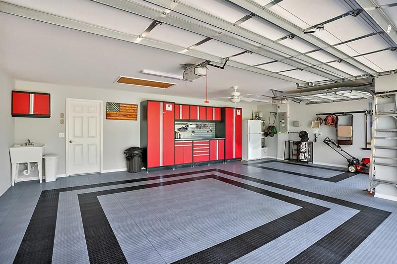 2 Car + GC Garage w/tile floor, custom cabinets & workbench