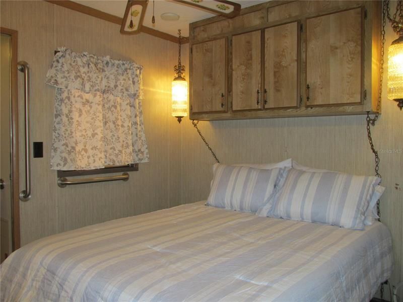 The cozy bedroom has a queen sized bed, and handrails to assist you with getting up and down.