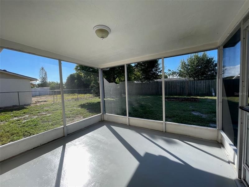 Screened back patio with new epoxy flooring