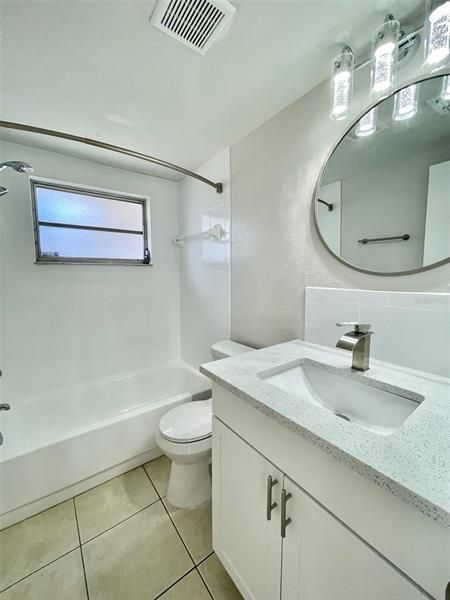 Remodeled bath with new toilet, vanity and quartz