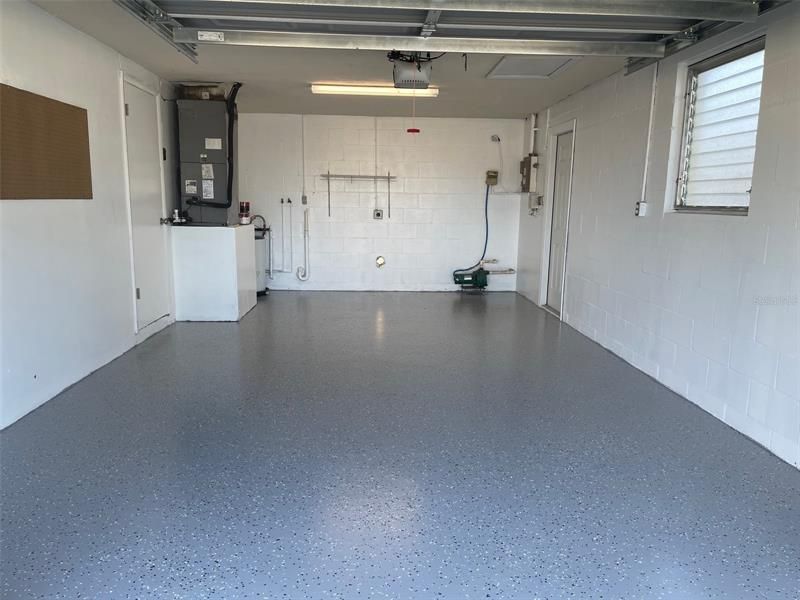 Garage newly painted walls and epoxy flooring.